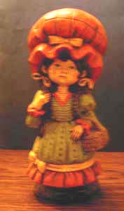 Ceramic Girl with Big Orange Hat carrying Basket Pic 1